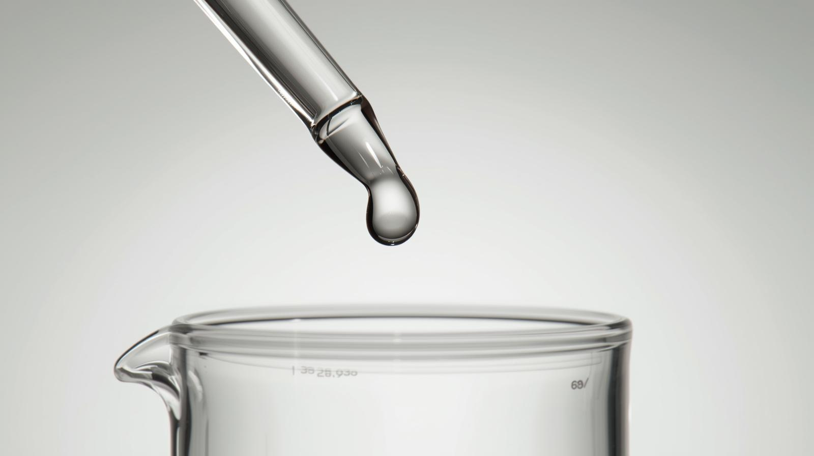 Measured droplet in laboratory glassware illustrating consistency and control.