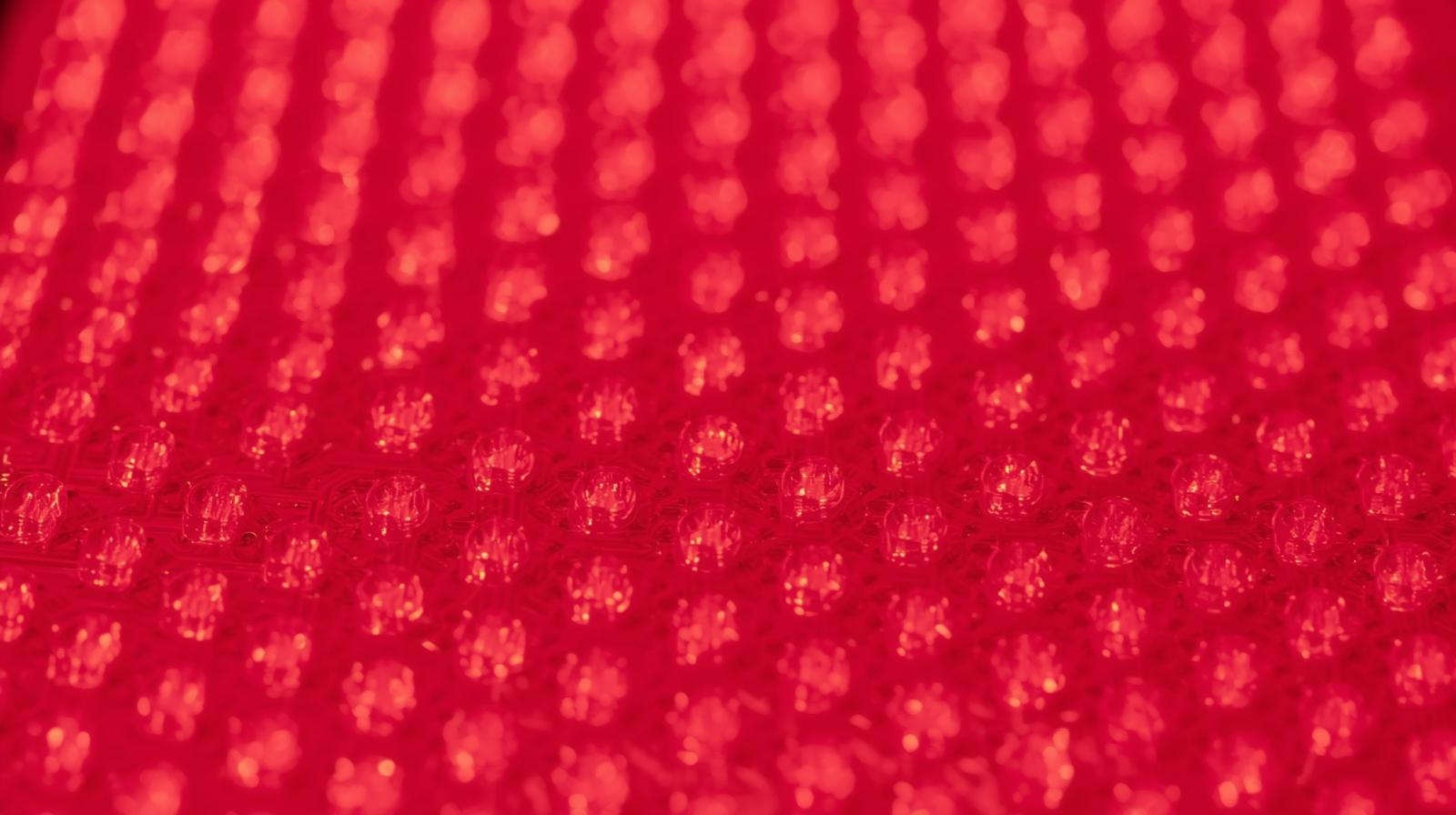  Macro close-up on the precise, clean grid of emitters on a clinical-grade LED light therapy panel.